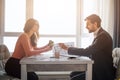 Couple buy or rent apartment together. Busy young woman hold colorful tissues in hands. Guy point on them and smile. Sit