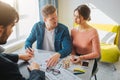 Couple buy or rent apartment together. Serious young man and woman look at each other. Guy put signature on documents Royalty Free Stock Photo