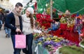 Couple buying Christmas flower at market Royalty Free Stock Photo