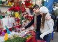 Couple buying Christmas flower at market Royalty Free Stock Photo