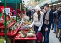 Couple buying Christmas flower at market Royalty Free Stock Photo