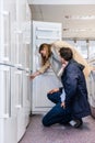 Couple Buying Domestic Refrigerator In Hypermarket