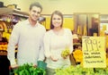 Couple buying fresh seasonal fruits in market Royalty Free Stock Photo