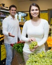 Couple buying fresh seasonal fruits in market Royalty Free Stock Photo