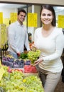 Couple buying fresh seasonal fruits in market Royalty Free Stock Photo