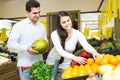 Couple buying fresh seasonal fruits in market Royalty Free Stock Photo