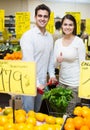 Couple buying fresh seasonal fruits in market Royalty Free Stock Photo