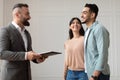 Couple Buying New Apartment Talking With House Agent Royalty Free Stock Photo