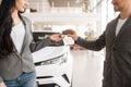 Couple buying new car, man gives the key to woman Royalty Free Stock Photo