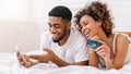 Couple buying online with smartphone and credit card Royalty Free Stock Photo