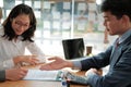 Couple buying renting house car signing mortgage insurance purchase order contract agreement with realtor real estate agent Royalty Free Stock Photo