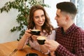 Couple In Cafe Drinking Coffee