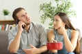 Couple callling to insurance for home leaks