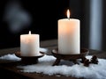 couple of candles sitting on top of a table covered in snow