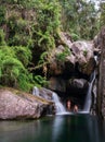 Secret Waterfall Cave: Couple's Long Exposure Photo Shoot in Emerald Green Water Royalty Free Stock Photo