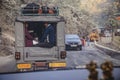 Couple in the car with belongings on top running on the road near Bagdogra, Darjeeling, India.