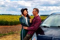 Couple on car road trip travel having coffee break outdoors smiling happy. Royalty Free Stock Photo