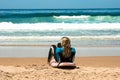 A woman in a wetsuit lies on the beach of Cordoama Royalty Free Stock Photo