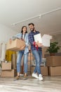 Couple carrying boxes while moving in together Royalty Free Stock Photo