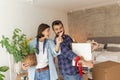 Couple carrying cardboard boxes while moving in new apartment Royalty Free Stock Photo