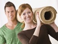 Couple Carrying Carpet Roll Royalty Free Stock Photo