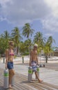 Couple carrying Scuba Tanks in the Caribbean