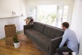 Couple Carrying Sofa Into New Home On Moving Day Royalty Free Stock Photo