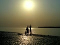 Couple catching fishes together with net in sea beach for livelihood