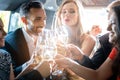 Couple celebrating party in limousine with friends Royalty Free Stock Photo