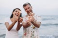 Couple celebrating with sparklers at the beach