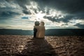 Couple of ceramic figures hugging on background mountain sunset, silhouette two romantic people cuddling and looking on rear view Royalty Free Stock Photo