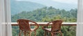 Couple chairs on balcony of countryside home or homestay with mountain view background in the morning