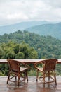 Couple chairs on balcony of countryside home or homestay with mountain view background in the morning