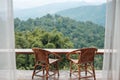 Couple chairs on balcony of countryside home or homestay with mountain view background in the morning