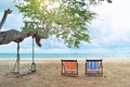 Couple Chairs on the sandy beach near the sea