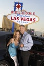 Couple With Champagne Flutes Disembarking From Car Royalty Free Stock Photo