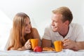 Couple chatting and eating in bed