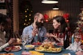 Couple chatting at family christmas home party Royalty Free Stock Photo