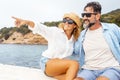 Couple of cheerful mature couple of tourists man and woman sitting inside a boat enjoying excursion tour admiring coast and ocean Royalty Free Stock Photo