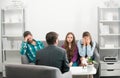 Couple with child teenager discussing problems in family with family psychologist. Parental concept. Royalty Free Stock Photo