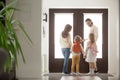Couple with children in hallway gather for a walk Royalty Free Stock Photo