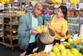 Couple choosing bananas in fruit and vegetable section of supermarket Royalty Free Stock Photo