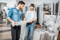 Couple choosing ceramic tiles in the shop Royalty Free Stock Photo