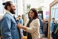 Couple choosing clothes at vintage clothing store Royalty Free Stock Photo