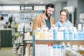 Couple choosing cosmetics in the pharmacy Royalty Free Stock Photo