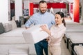 couple choosing folding mattress together in furniture store Royalty Free Stock Photo