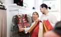 Couple choosing jacket at clothing shop Royalty Free Stock Photo