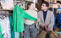 Couple is choosing jacket for her Royalty Free Stock Photo