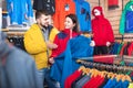 Couple choosing jacket in store Royalty Free Stock Photo