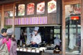 Couple is choosing meals at an outdoor take away restaurant in water town Wuzhen, China